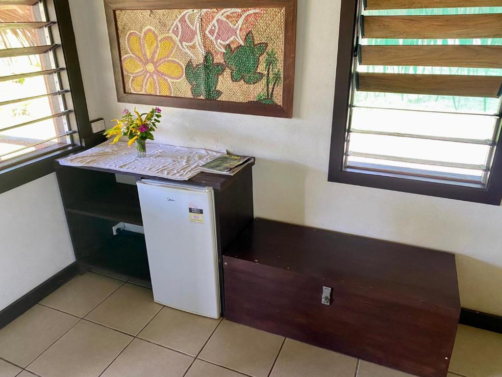 a small kitchen with a counter and a refrigerator at Serenity Bungalows in Port Olry