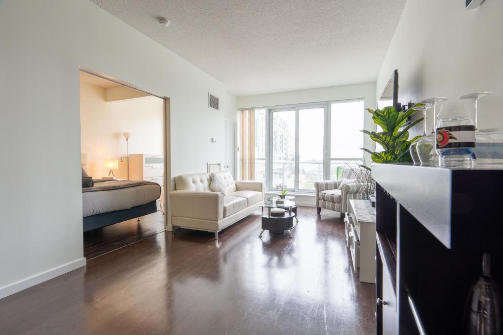 a living room with a couch and a bed in a room at Harbour Front Luxury Condo 2 Bed 2 Bath in Toronto