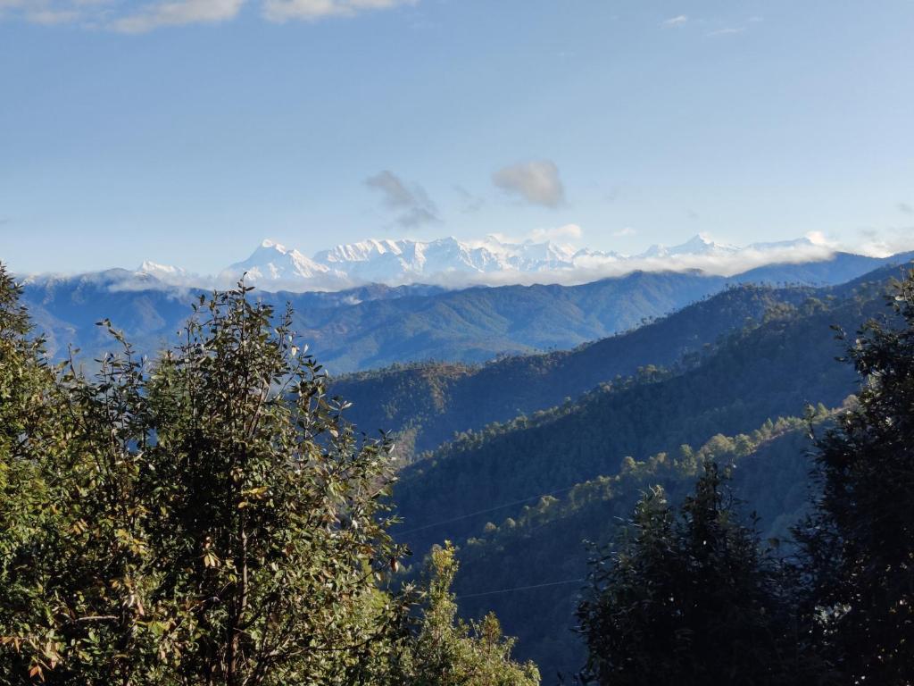 a view of a mountain range with snow capped mountains at Oakakhi Stays, Deluxe room in Rānīkhet