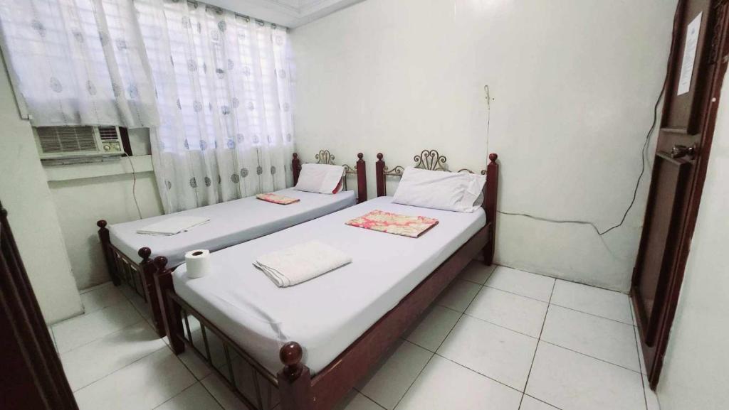 Katil atau katil-katil dalam bilik di Goland Pension House & Dormitory by SMS Hospitality