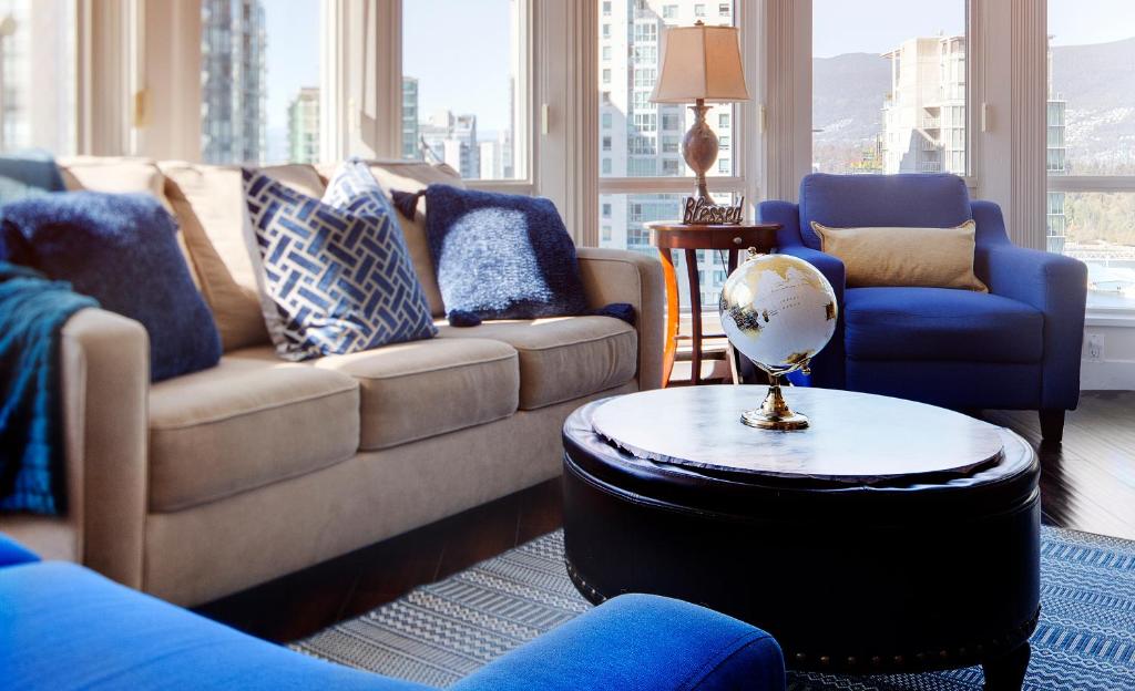 a living room with couches and a globe on a table at Breathtaking Downtown Condo with Stunning Harbor Views! in Vancouver