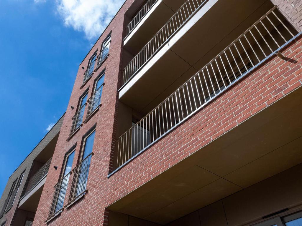 a red brick building with vents on the side of it at Modern Apartments with Balcony in Merton near Wimbledon by Sojo Stay in Mitcham