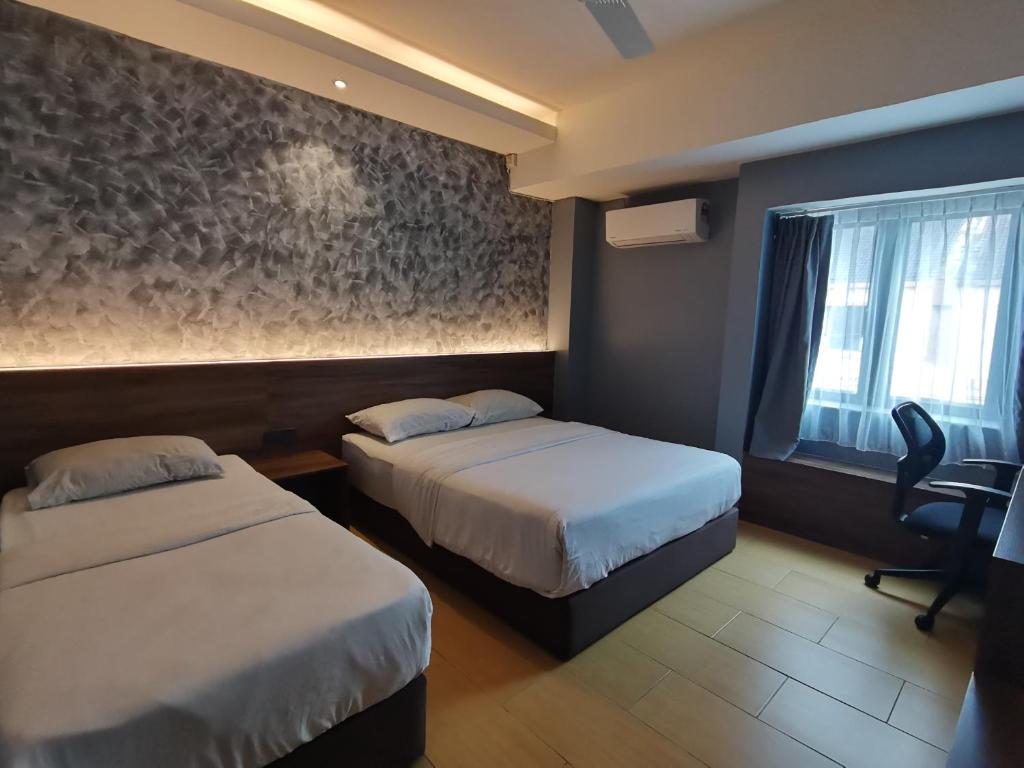 Katil atau katil-katil dalam bilik di Lumut Hotel
