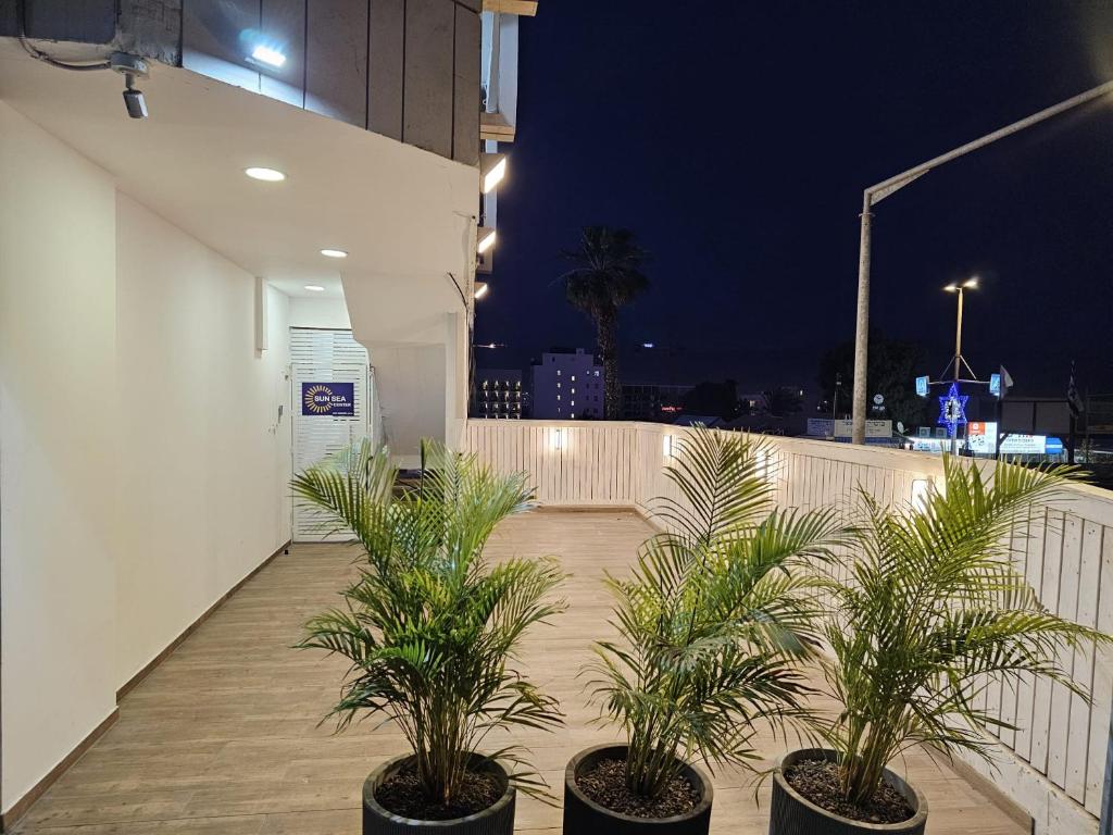 a row of potted plants on a balcony at night at Sun Sea Center in Eilat