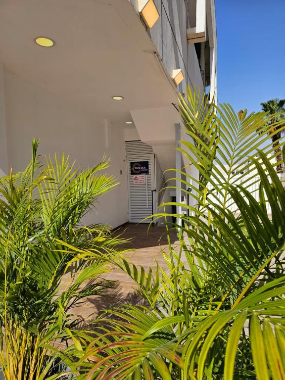 a hallway with plants in front of a building at Sun Sea Center in Eilat