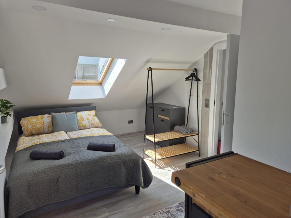 a bedroom with a bed and a skylight at BlueLine Apartments am Wörthersee in Schiefling am See