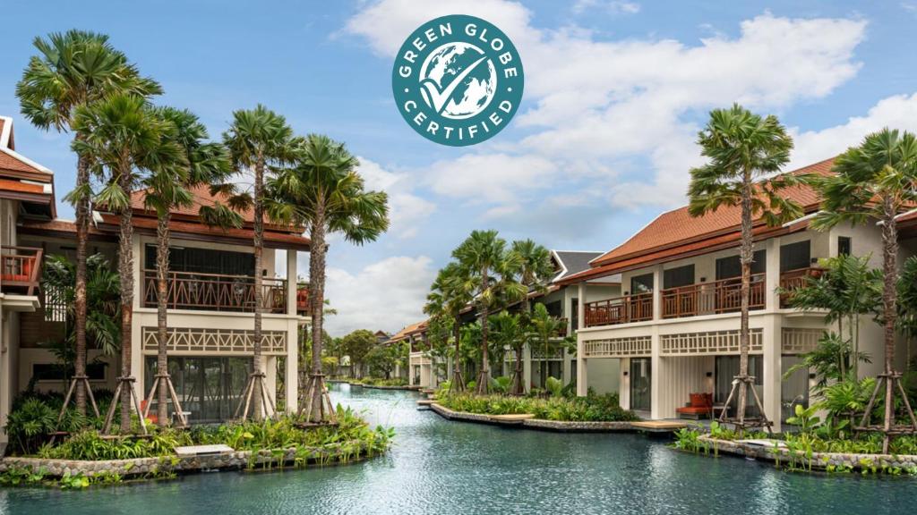 a resort with a river between two buildings at Grand Mercure Khao Lak Bangsak in Khao Lak