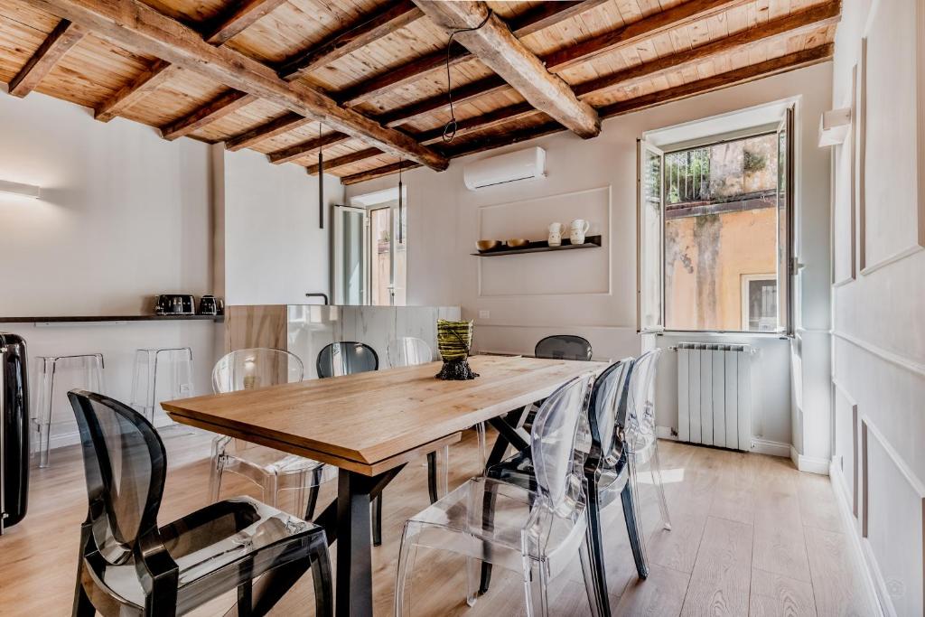 a dining room with a wooden table and chairs at APT ROME - Vittoria Palace in Rome