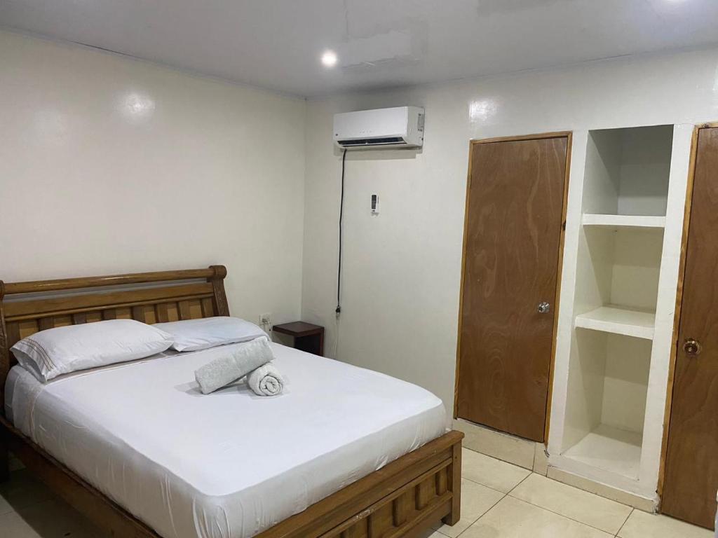 a bedroom with a bed and a closet at Miss Titi's Native Lodge in San Andrés
