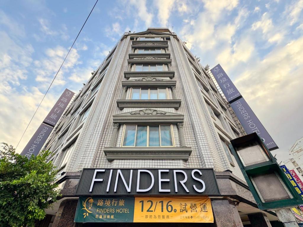 a tall building with a sign on the side of it at Finders Hotel Hualien Station in Hualien City