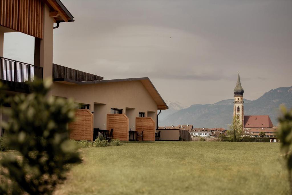 a building with a clock tower in the background at Gutshof Ebner in San Paolo