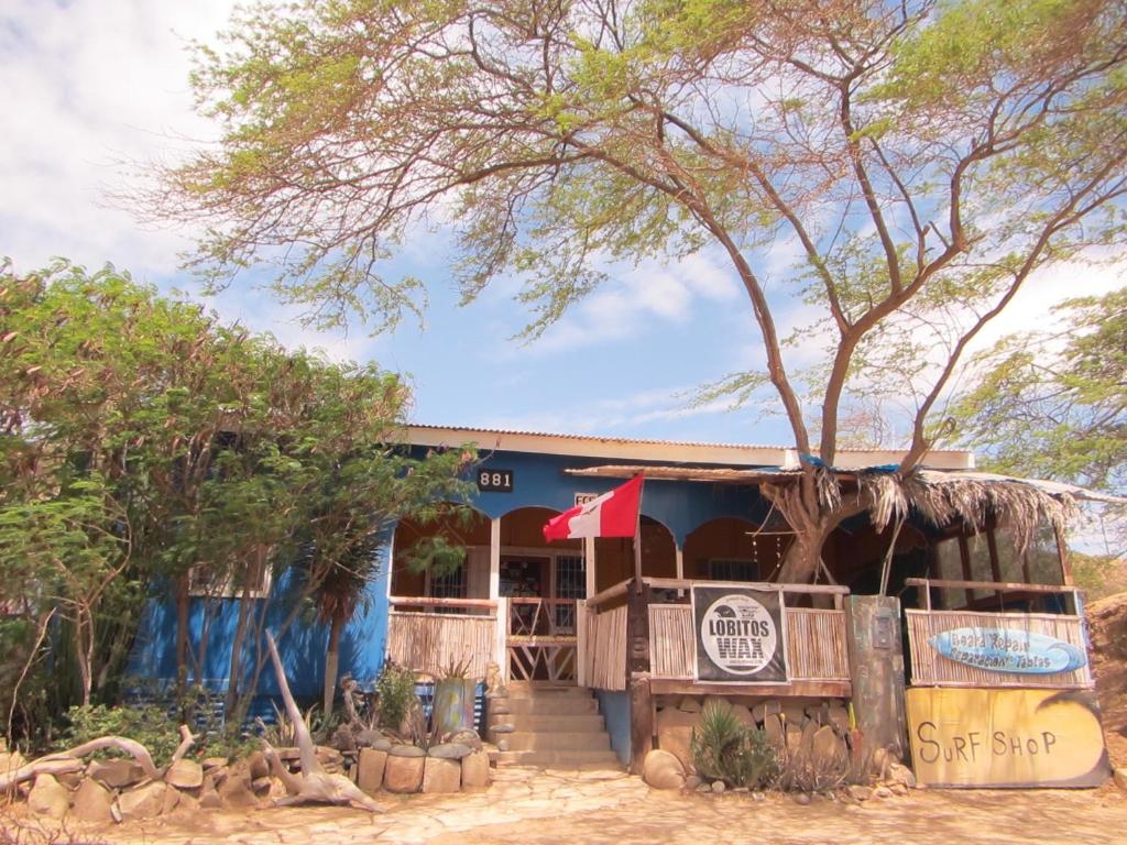 a restaurant with a tree in front of it at Casa De Darwin in Lobitos