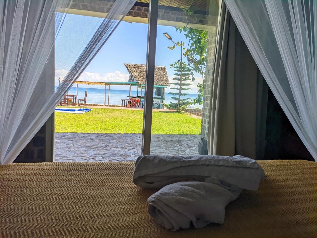 a bedroom with a bed with a view of the ocean at blue fenix in Mahavelo