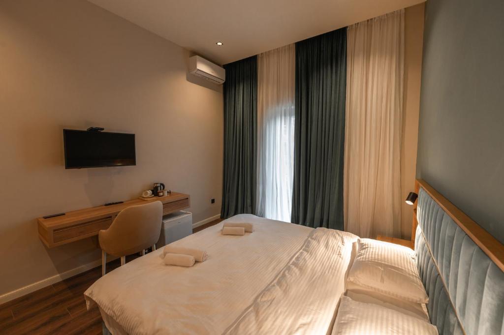 Postel nebo postele na pokoji v ubytování Central Hotel Kutaisi
