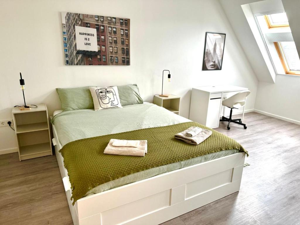 a bedroom with a bed with two towels on it at Palace Quarter 2 Peaceful Modern Central Top Floor Apartment in Budapest