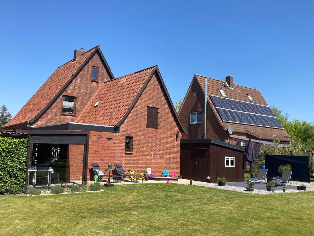 a large brick house with solar panels on the roof at Ferienhaus HERNA WING120 in Oberndorf