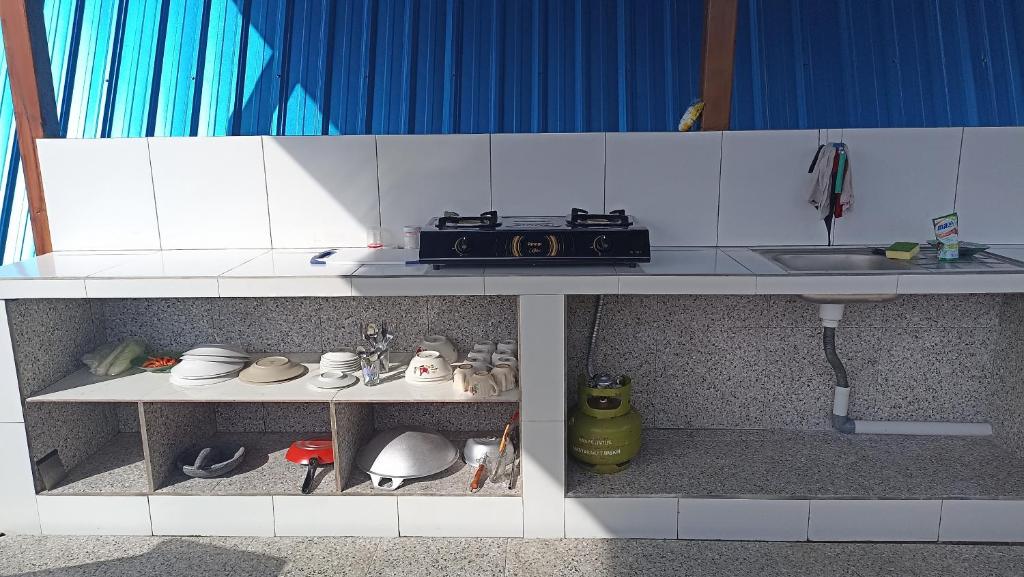 a toy kitchen with a stove and a sink at Puri Pilihani Hostel in Munduk
