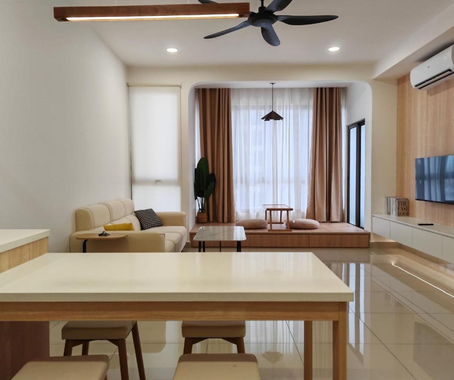 a living room with a table and a ceiling fan at Mykey Bali A-10-06 Melaka City in Melaka