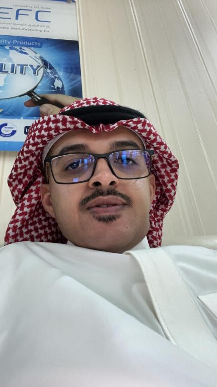 Ein Mann mit Brille liegt auf einem Bett in der Unterkunft الرياض in Riad
