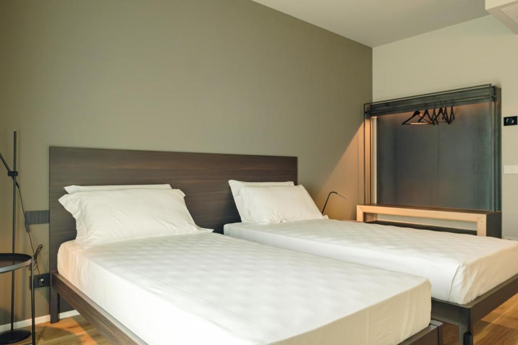 Postel nebo postele na pokoji v ubytování Camoma Aparthotel - Suites Apartments