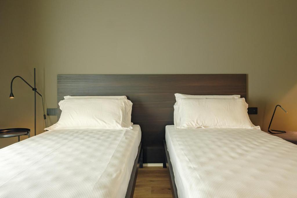 Postel nebo postele na pokoji v ubytování Camoma Aparthotel - Suites Apartments