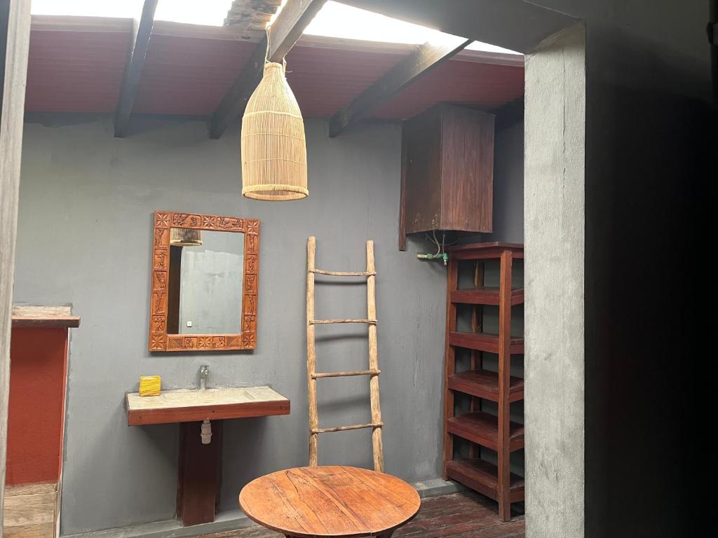 a bathroom with a sink and a ladder and a mirror at blue fenix in Mahavelo
