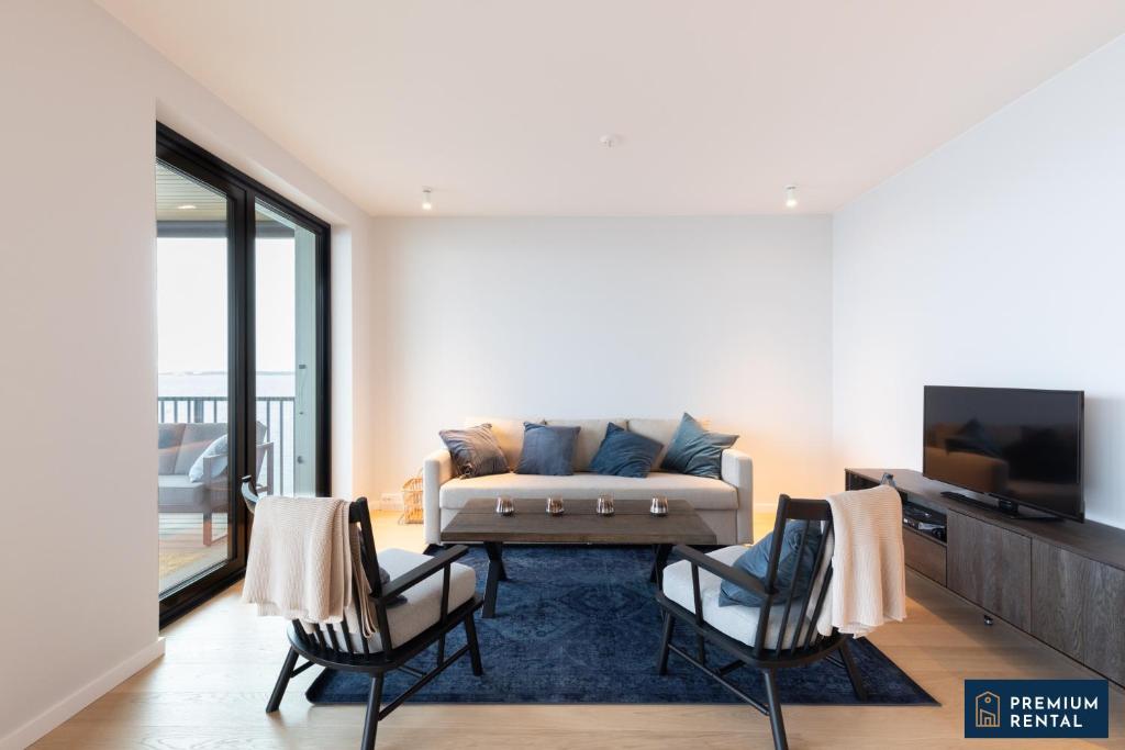 a living room with a couch and two chairs at C44 Ultimate Luxury Waterfront Penthouse in Hanko