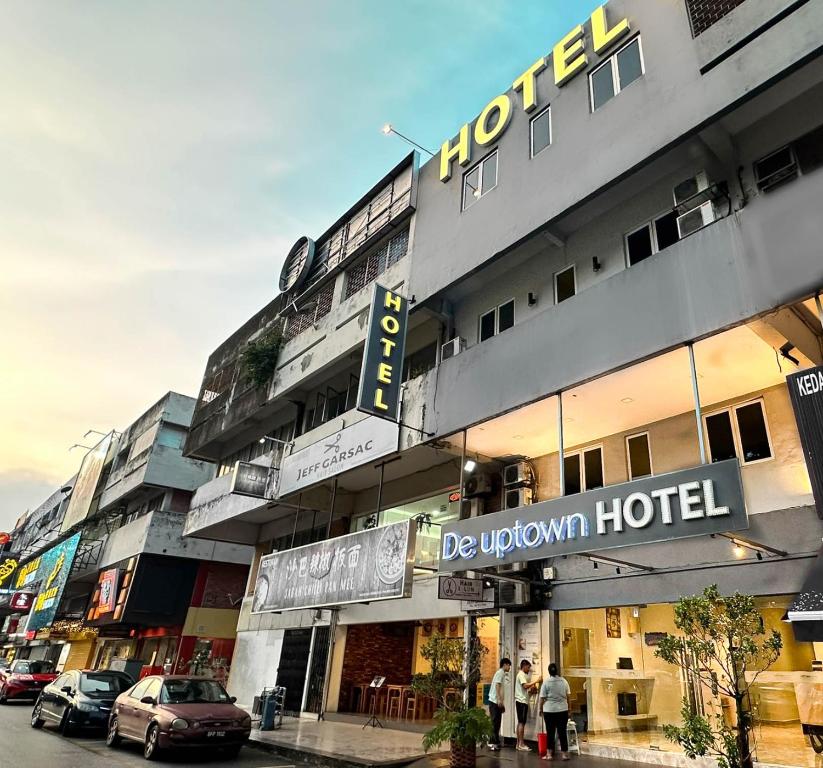 a building with a hotel with people standing in front of it at De UPTOWN Hotel @ SS2 in Petaling Jaya