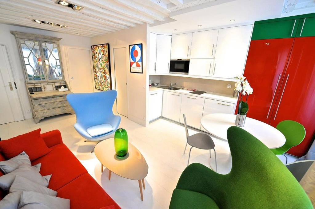 sala de estar con sofá rojo y mesa en Notre Dame In Full Colors en París