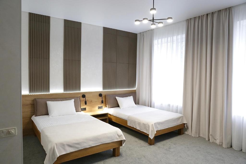 Postel nebo postele na pokoji v ubytování Duboviy Gai Hotel