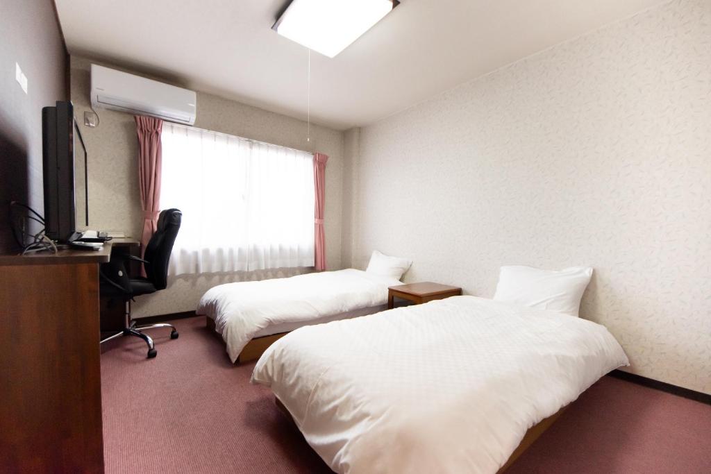 Postel nebo postele na pokoji v ubytování Yamato Saidaiji Hotel SINDAI