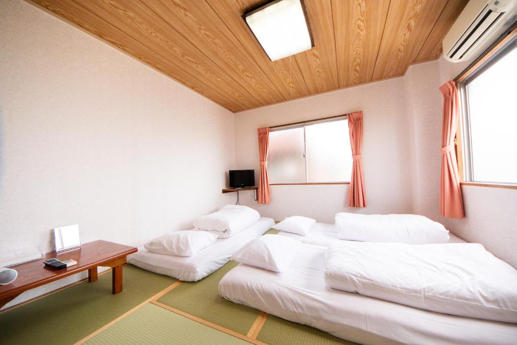 Postel nebo postele na pokoji v ubytování Yamato Saidaiji Hotel SINDAI