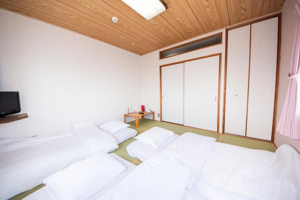 Postel nebo postele na pokoji v ubytování Yamato Saidaiji Hotel SINDAI