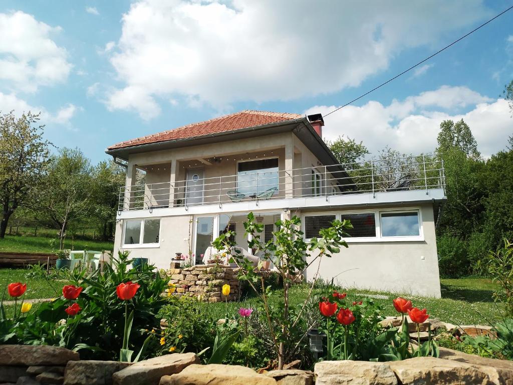 a house with a balcony on top of it at Apartment Pirol: Dorf Hideaway Gornja Breza in Breza