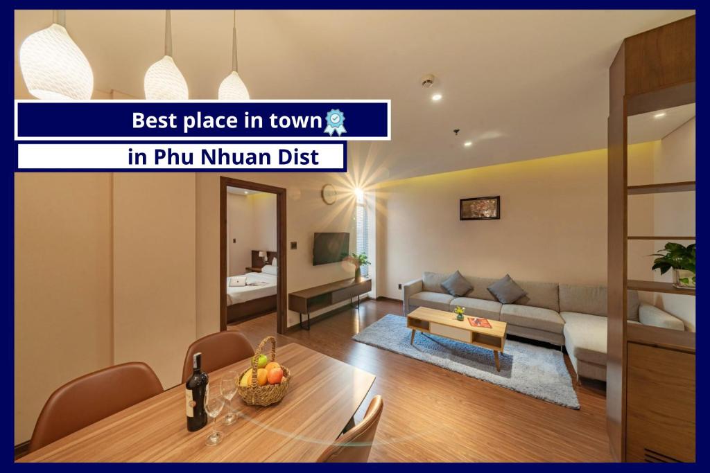 a living room with a table and a couch at DHTS Business Hotel & Apartment in Ho Chi Minh City