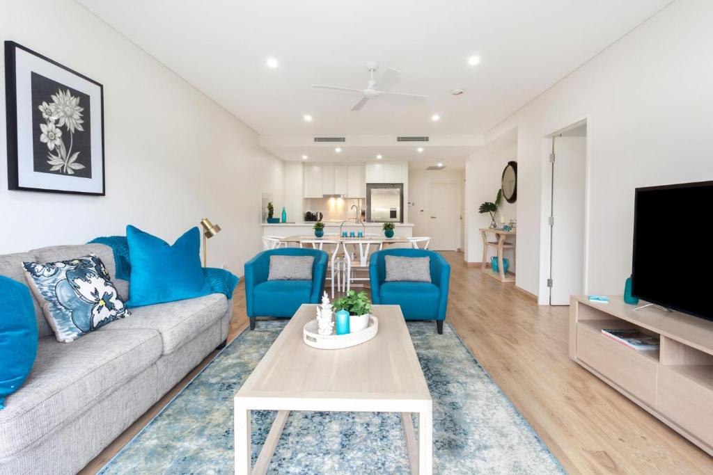 a living room with a couch and a table at Blissful Bream in Sydney