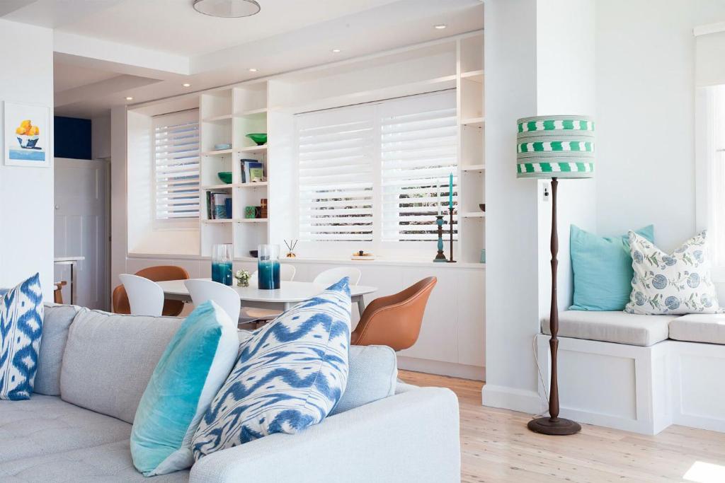 a living room with a couch and a table at Barefoot in Bronte IH in Sydney