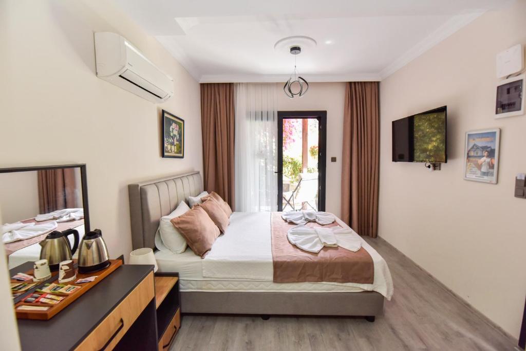 Кровать или кровати в номере Mykonut Boutique Suites