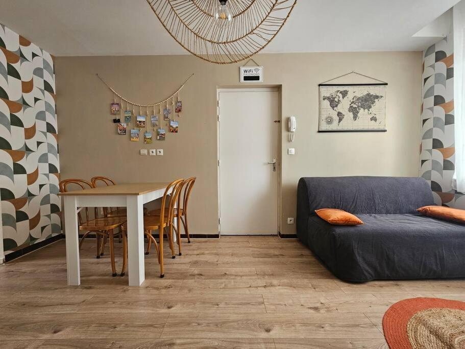 un salon avec une table et un canapé dans l'établissement Appartement Cœur de Ville !, à Saint-Omer