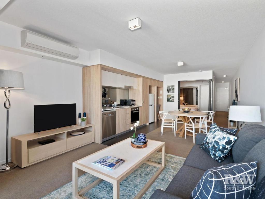 a living room with a couch and a table at One Oak in Brisbane