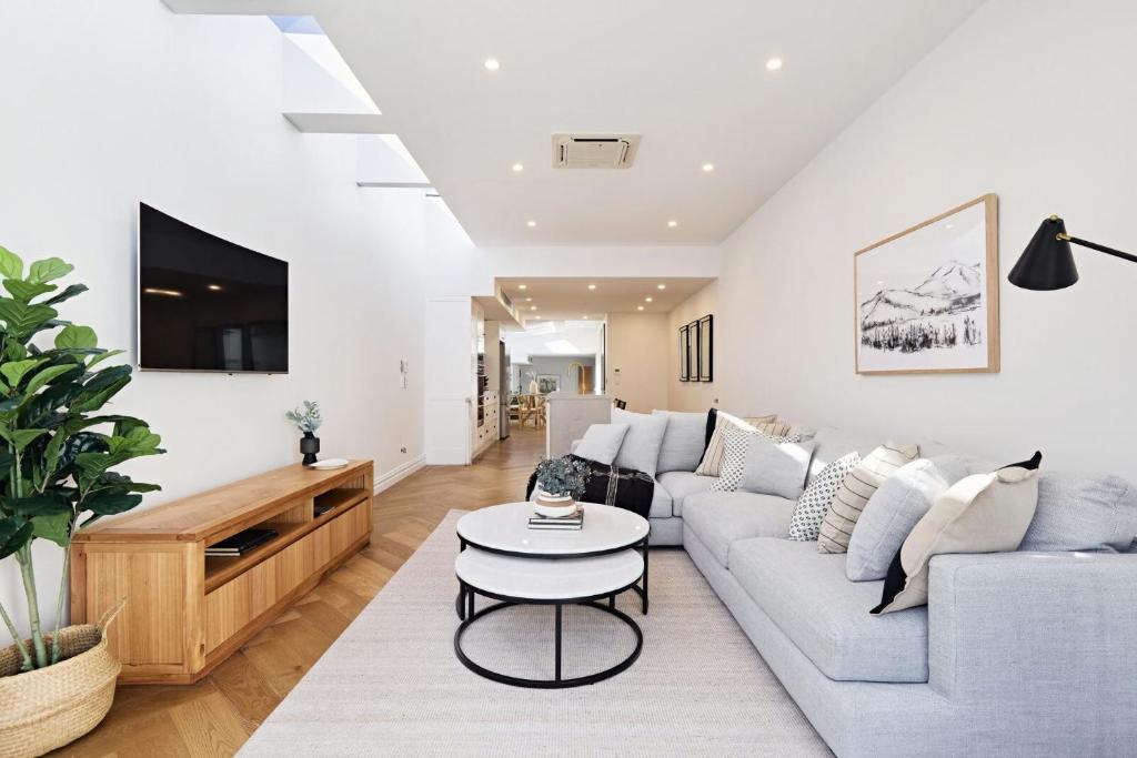 a living room with a couch and a table at Royal Redfern Isyd in Sydney