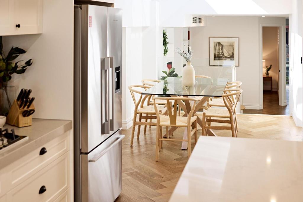 a kitchen and dining room with a table and chairs at Royal Redfern Isyd in Sydney