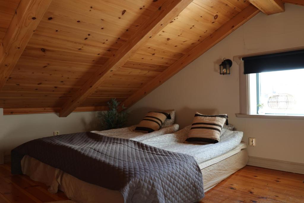 a bedroom with a bed with pillows on it at Fryksas Chalet in Fryksås