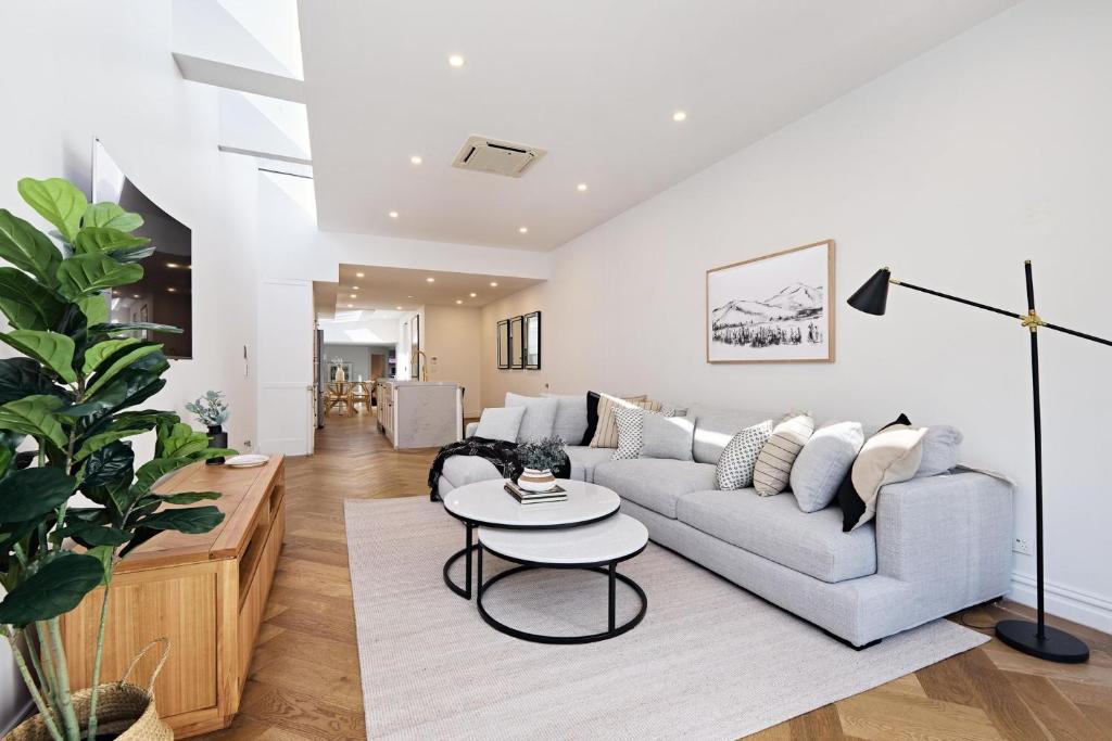 a living room with a couch and a table at Royal Redfern Isyd in Sydney