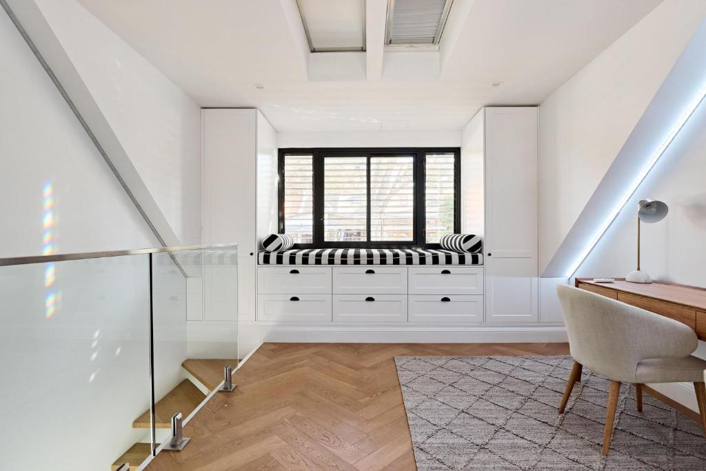 a home office with a bench in the window at Royal Redfern Isyd in Sydney
