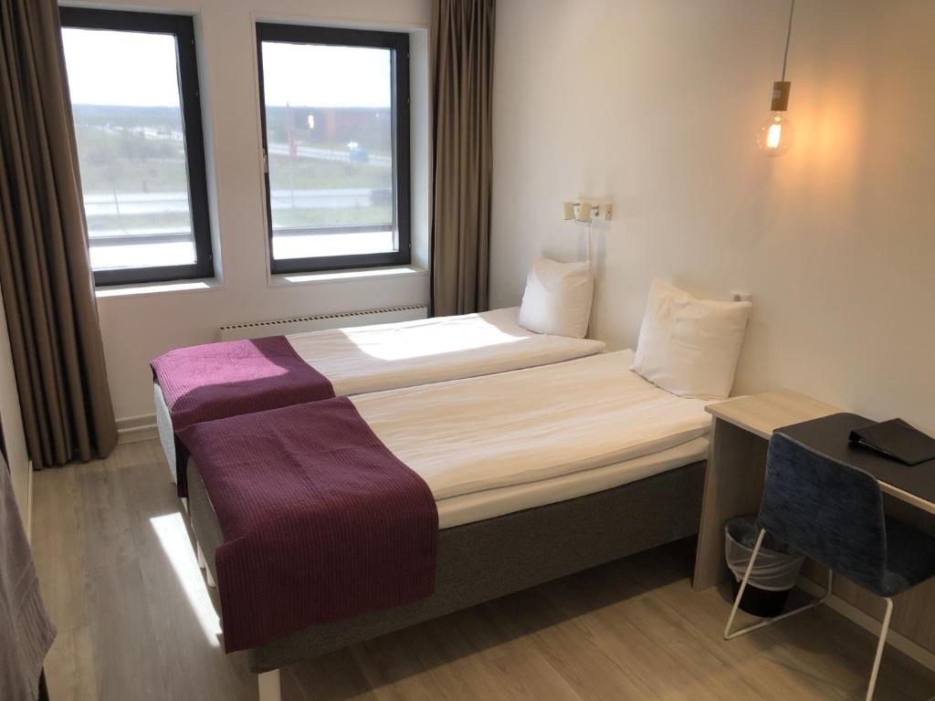 Postel nebo postele na pokoji v ubytování Hotell Fyrislund