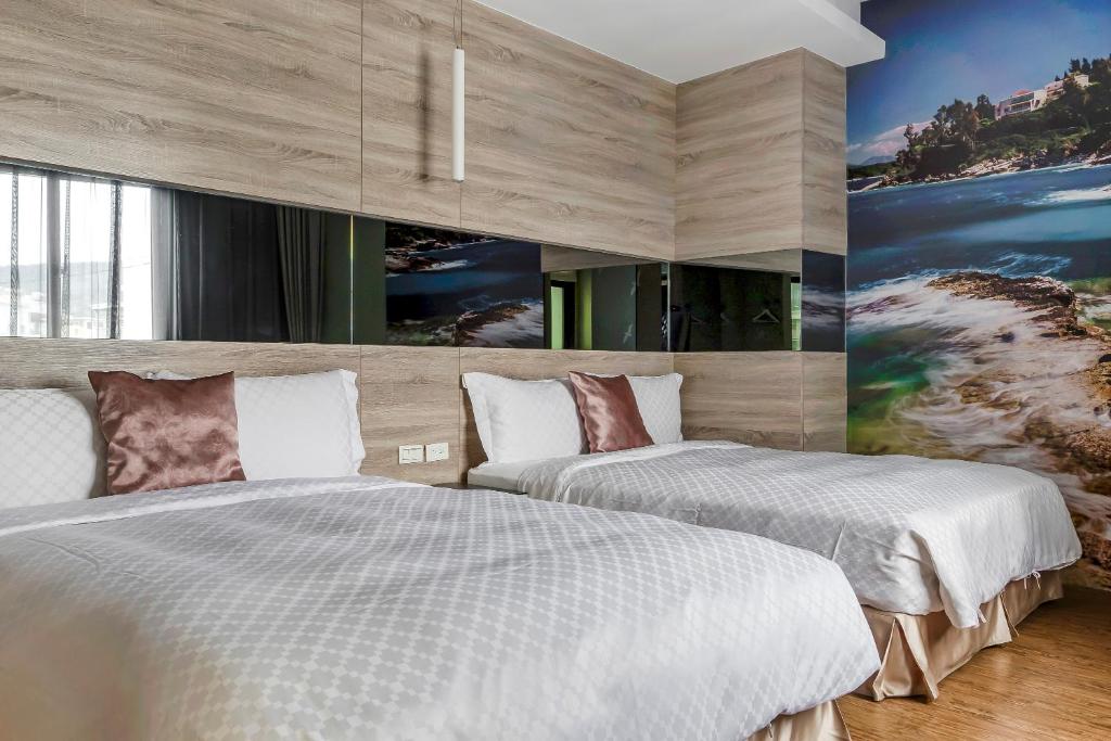 Postel nebo postele na pokoji v ubytování Pacific Inn