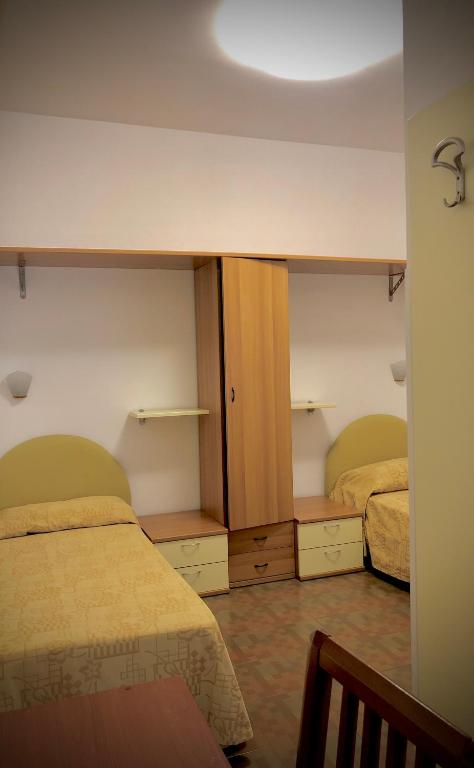 Postel nebo postele na pokoji v ubytování Hotel La Parigina