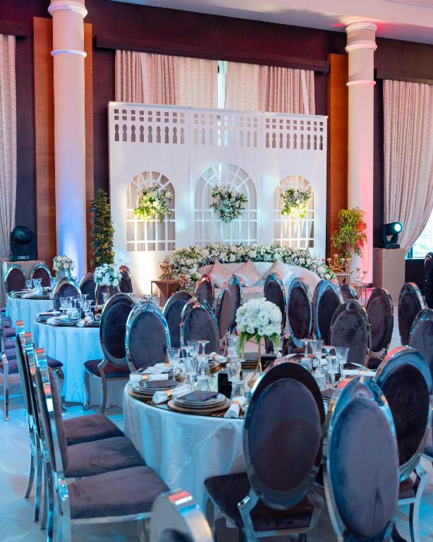 a set of tables and chairs in a banquet hall at Waves Aqua Resort in Kenitra