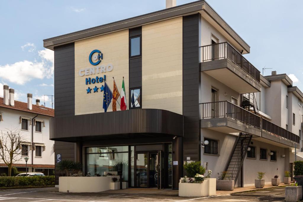 a building with a sign on the front of it at CENTRO HOTEL in Marcon